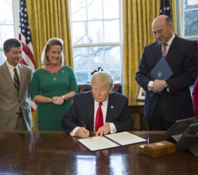 President Trump signs an executive order in the White House on Friday.